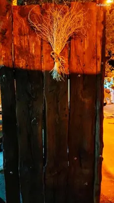 a close up of a wooden door with grass on it at Grandma's house in Wadi Musa