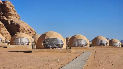 a row of domed buildings in the desert at Sun Luxury Rum Camp in Wadi Rum