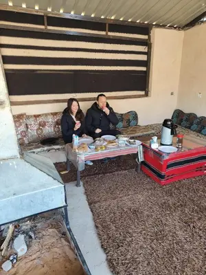 a man and a woman sitting on a couch at Talal Wadi Rum in Wadi Rum