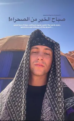 a man wearing a scarf around his head at Talal Wadi Rum in Wadi Rum