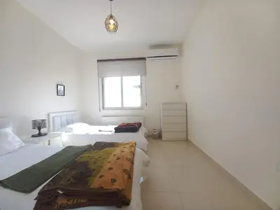 a bedroom with two beds and a window at Shmeisani homes central location near Abdali in Amman