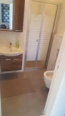 a bathroom with a shower and a sink and a toilet at Shmeisani homes central location near Abdali in Amman