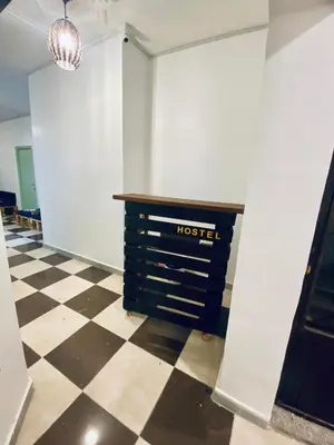 a room with a hotel sign on a checkered floor at Friends Oasis in Aqaba