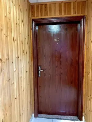 a wooden door in a room with wooden walls at Amir Palace Hotel in Aqaba