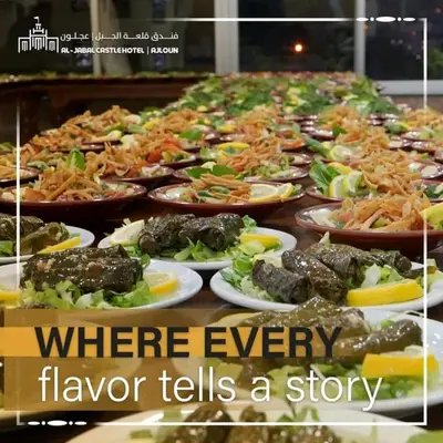 a table with many plates of food on it at Al-jabal castle Hotel - Ajloun in Ajloun