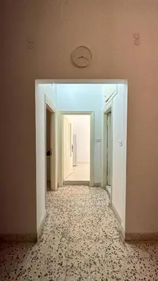 an empty room with a hallway with a hallwayngthngthngthngthngthngthngth at Turkuaz Aparment in Amman