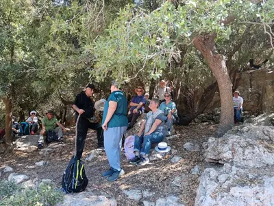 a group of people sitting on rocks under a tree at North Jewel 2023 in Ajloun