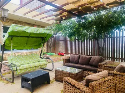 a patio with a couch and chairs and a table at North Jewel 2023 in Ajloun