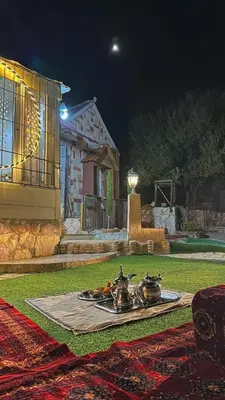 a couple of pots and pans on a table in a yard at Mount lareen cottage كوخ جبل لارين in Ajloun