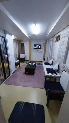 a living room with a couch and a table at Mount lareen cottage كوخ جبل لارين in Ajloun