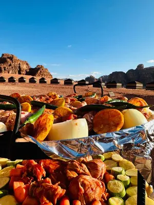 a bunch of different types of food on a table at Milk way desert in Wadi Rum