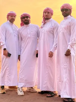 a group of men dressed in white standing in the desert at Milk way desert in Wadi Rum