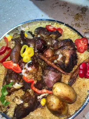 a plate of food with meat and vegetables on it at Petra Hills House in Wadi Musa