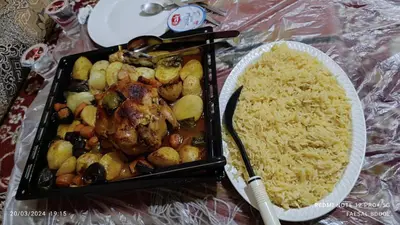 a tray of food with meat and potatoes and rice at Petra Magic Guest House in Wadi Musa