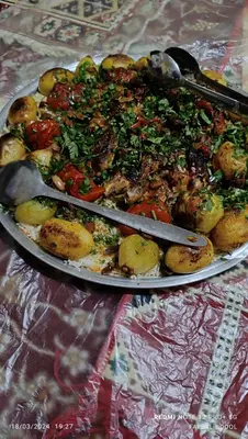 a plate of food with vegetables on a table at Petra Magic Guest House in Wadi Musa