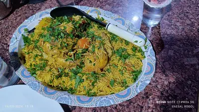 a bowl of rice with a spatula on a table at Petra Magic Guest House in Wadi Musa