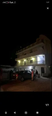 a car parked in front of a building at night at Petra Magic Guest House in Wadi Musa
