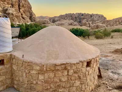 a stone building with a dome in the desert at Pink city cottage in Wadi Musa