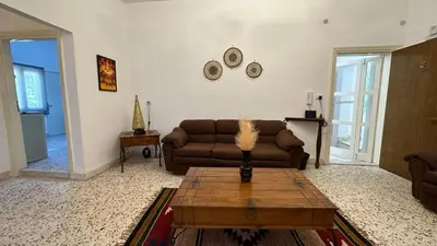a living room with a couch and a coffee table at The vintage apartment in Amman