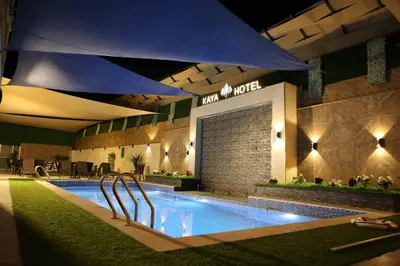 a swimming pool in a hotel at night at Kaya Hotel Amman in Amman