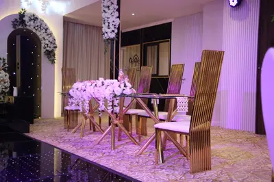 a table and chairs with purple flowers on it at Kaya Hotel Amman in Amman