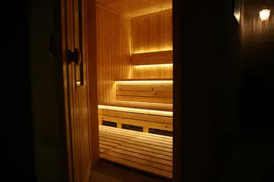 a wooden sauna looking out of a door at Kaya Hotel Amman in Amman