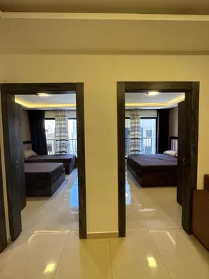 two mirrors in a room with two beds at modern 2bedroom for rent Abdoun in Amman