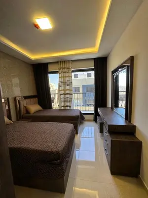 a hotel room with two beds and a window at modern 2bedroom for rent Abdoun in Amman