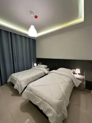 two beds in a hotel room with a red ball at modern 2bedroom for rent abdoun2 in Amman