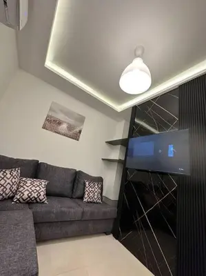 a living room with a couch and a flat screen tv at modern 2bedroom for rent abdoun2 in Amman