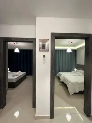 a bedroom with two beds and two mirrors at modern 2bedroom for rent abdoun2 in Amman