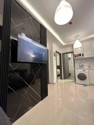 a living room with a flat screen tv on a wall at modern 2bedroom for rent abdoun2 in Amman