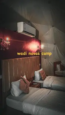 two beds in a room with a wadi movie camp at wadi novas camp in Wadi Rum