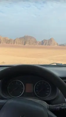 a dashboard of a car with a view of the desert at wadi novas camp in Wadi Rum