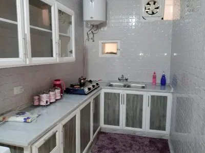 a kitchen with white cabinets and a sink at petra sun apartment in Wadi Musa