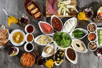 a table with many different dishes of food on it at petra sun apartment in Wadi Musa