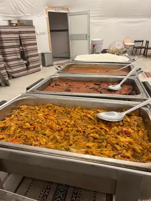 a bunch of food in trays in a room at Wadi Rum Rose Luxury camp in Wadi Rum
