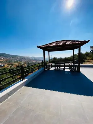 a picnic table on the roof of a building at Souf view in Jerash