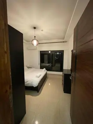 a bedroom with a bed and a room with a window at apartment 60m 1bedroom for rent2 in Umm Uthainah