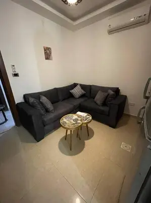 a living room with a couch and a table at apartment 60m 1bedroom for rent2 in Umm Uthainah