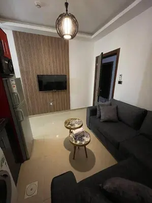 a living room with a couch and a table at apartment 60m 1bedroom for rent2 in Umm Uthainah