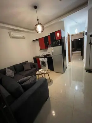 a living room with a couch and a kitchen at apartment 60m 1bedroom for rent2 in Umm Uthainah