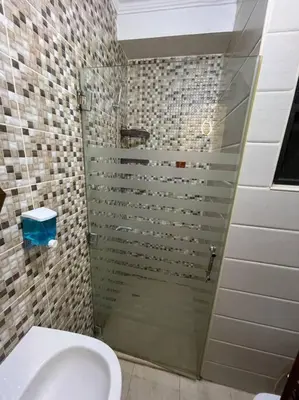 a bathroom with a glass shower with a toilet at apartment 60m 1bedroom for rent3 in Umm Uthainah
