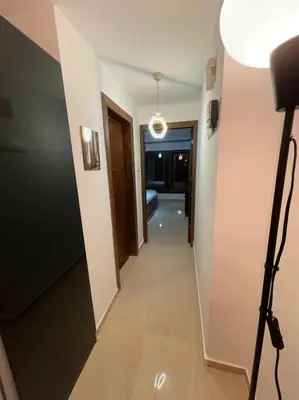 a hallway leading to a room with a bed and a light at apartment 60m 1bedroom for rent3 in Umm Uthainah