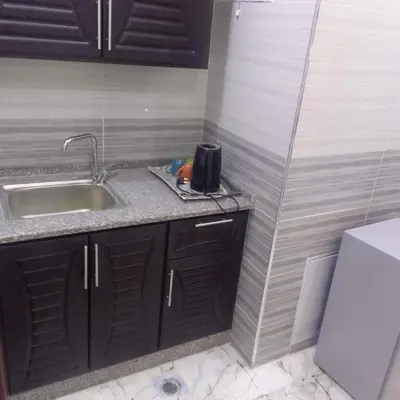 a small kitchen with a sink and a counter top at dream house hotel in Jerash