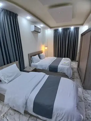 a hotel room with two beds and a window at dream house hotel in Jerash