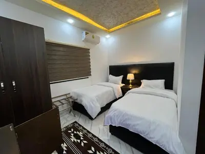 a hotel room with two beds and a window at Mansi Residence in Wadi Musa