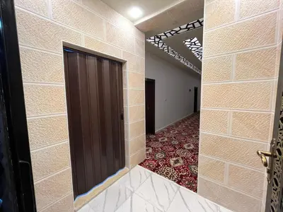 a hallway with a door and a red carpet at Mansi Residence in Wadi Musa