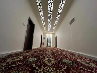 an empty hallway with a persian carpet in a building at Mansi Residence in Wadi Musa