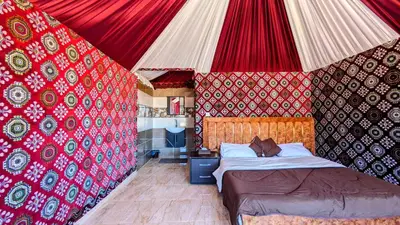 a bedroom with a bed in a tent at WhyDesert Camp & Tours in Wadi Rum